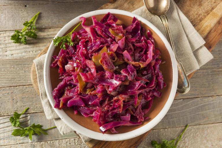 a bowl of red cabbage braised with apples